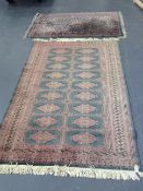 An Oriental rug of Bokhara design and another small rug, largest 180 x 128cm.