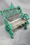 A Coalbrookdale pattern cast iron garden seat with wooden slatted seat and scrolled supports.