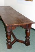 A good 17th Century and later oak refectory table. Three plank top over carved frieze and heavy