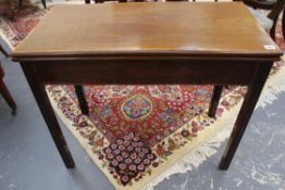 A Georgian inlaid and crossbanded mahogany tea table. Hinged moulded edge top. Straight moulded