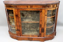 An antique Victorian inlaid walnut breakfront display cabinet. Brass trim, bowed sides. Plinth base.