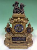 A Victorian gilt and silvered mantel clock. Surmounted with Cherubs. Silvered dial with raised