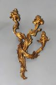 A French Louis XV style three light ormolu wall sconce. Elaborate scrolling foliate decoration. 63cm