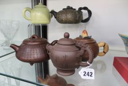 Five assorted Chinese terracotta teapots.