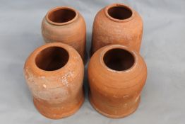 Four Vintage terracotta rhubarb forcers. Bulbous form with ribbed decoration. Tallest 40cm high.