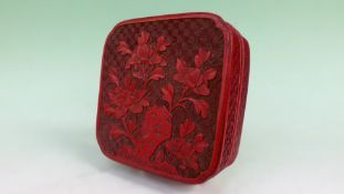 A Chinese square shaped cinnabar lacquer lidded box with flowering prunus. 13cm.