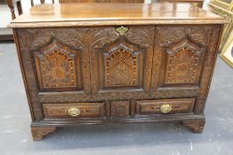 An 18th Century and later oak mule chest. Fitted with two base drawers, inlaid geometric designs.