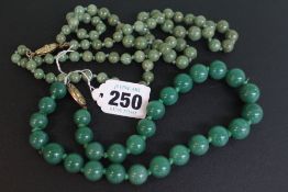 Two jadeite bead necklaces.