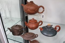 Five assorted Chinese terracotta teapots.