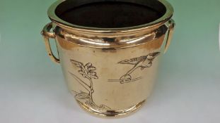 An Oriental polished bronze twin handle jardiniere decorated with geese in flight. 24cm high.