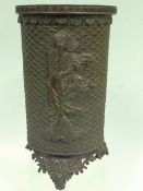 A late 19th Century Chinese bronze cylindrical vase. With embossed figures on pierced arched feet.