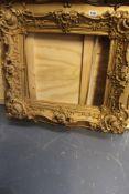 A 19th Century gilt gesso decorated frame. Sight size 39 x 34cm and two others.