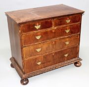 An 18th Century and later walnut and crossbanded chest of two short and three long drawers on turned