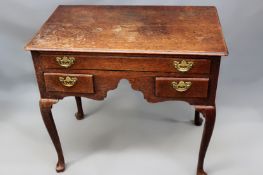 A George III oak lowboy. Moulded edge top over on long and two short drawers on cabriole legs.