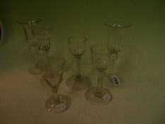 Two similar bell shaped cordial glasses with white spiral stems. 17cm high and four assorted glasses
