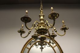 A heavy polished brass Dutch style six light chandelier. Lobed baluster shaft. Scroll arms. 60cm