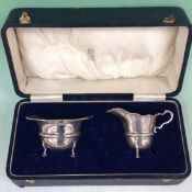 A cased silver cream jug and sucrier. Birmingham 1919. Together with a pair of silver sauce boats.