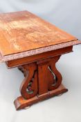 A Victorian carved pine library table. With apron drawer. Rectangular top with carved edge.