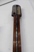 An early 19th Century mahogany cased stick barometer. Two piece ivory scale signed Davies (