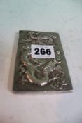 A Chinese silver coloured metal card case with repousse dragon designs. 10 x 6.5cm.