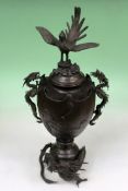 A late 19th Century Japanese bronze two handled vase with cover decorated with scenes of flying