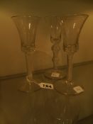 A pair of 19th Century glasses with bell shaped bowls, spiral stems and another similar. 16 and 16.