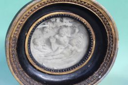 An antique oval plaque. Depicting the devil surprising Venus with Cupid in attendance. 13 x 14cm.