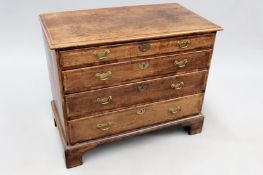 A George III country oak chest of four long crossbanded graduated drawers on bracket feet. 94cm wide