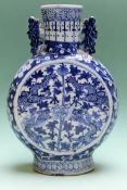A Chinese blue and white moon flask with dragon designs. 21cm high. A blue and white baluster vase