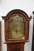 A George III mahogany cased 8 day longcase clock. Arched brass dial with painted moonphase and