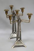 A pair of Arts and Crafts WMF three branch table candlesticks. With tripart base. 37cm high.