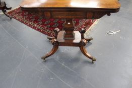 A Regency rosewood fold over card table with square stepped pillar. Platform base on four splayed
