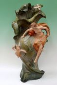 An Art Nouveau pottery vase with female figure and Cupid amidst bullrushes. 65cm high.