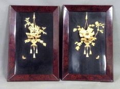 A pair of Japanese carved ivory and bone floral decorated lacquer panels. Floral motifs to frames.