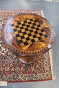A 19th Century rosewood circular table with inlaid chequerboard to top. Hexagonal pillar on circular