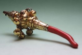 A 19th Century baby’s silver gilt rattle with eight attached bells, coral teething ring. Makers