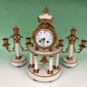 A 19th Century ormolu mounted marble drum head Portico clock and garniture. Floral swag decorated