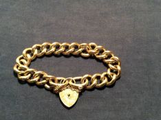A 9ct gold curb link bracelet with padlock clasp. 70grams.