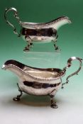 A pair of silver sauce-boats with scallop feet. London 1938. 19ozs.