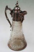 A late 19th Century glass claret jug with silver plated mounts and masked spout. 29cm high.