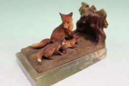 An Austrian style cold painted bronze bookend depicting a fox and two cubs playing. On onyx base.