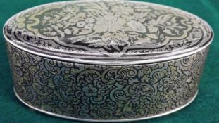 A 19th Century French silver niello decoration oval box with arabesque border. The lid inlaid with a