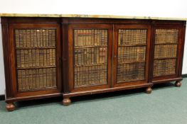 An early 19th Century and later breakfront low bookcase. Marble top over four panelled doors. Each