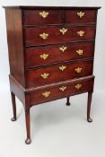 An 18th Century oak chest on stand. Moulded top over two short and four long drawers standing on