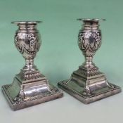 A pair of Victorian silver candlesticks with detachable sconces. Square pedestal bases. London 1881.