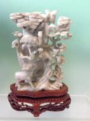 A Chinese jade lidded vase. Pale celadon with stork and deer decoration with plinth. 15cm high. (