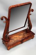 A mid Victorian mahogany swing toilet mirror with carved supports and two drawer base.