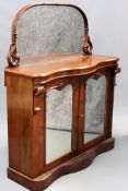 An early Victorian walnut chiffonier, mirror back with carved scroll frame over a pair of mirror
