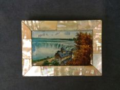 A Victorian mother of pearl card case with a reverse glass hand coloured print of Niagara Falls.