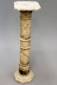 A alabaster pedestal with octagonal base. Turned column, square canted top. 99cm high x 26cm